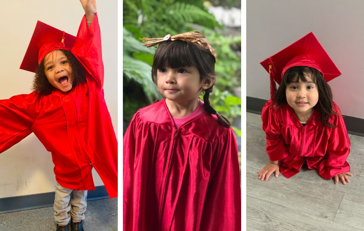 Three happy little girls in red graduation robes and red grad caps